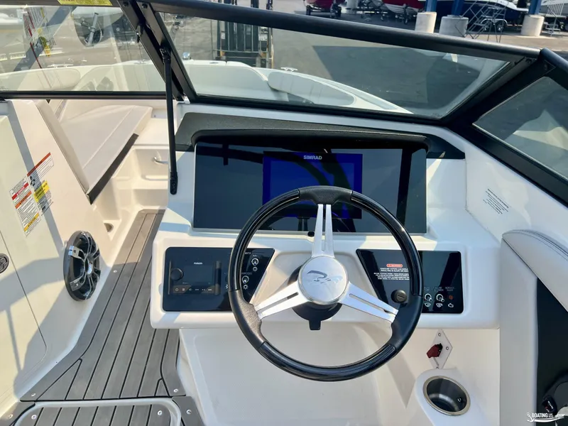 Slide: The Image of 2022 Sea Ray 190 Sport boat dashboard with steering wheel and navigation display. - 6