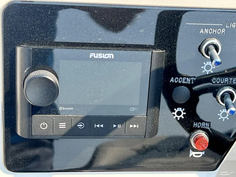 Slide: The Image of Fusion audio system and control panel on 2022 Sea Ray 190 Sport boat. - 7