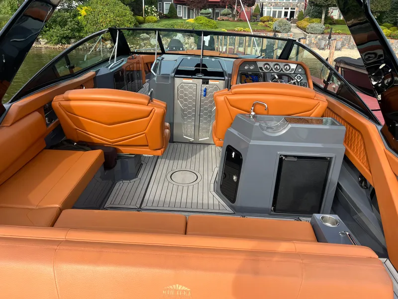 Slide: The Image of 2016 Cruisers Yachts 338 SOUTH BEACH interior with orange seating and modern dashboard. - 12
