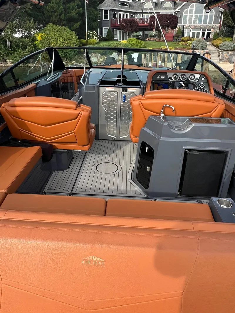 Slide: The Image of 2016 Cruisers Yachts 338 SOUTH BEACH interior with orange seating and modern dashboard. - 13