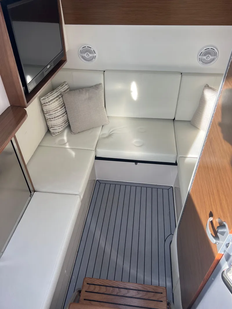 Slide: The Image of Interior of 2016 Cruisers Yachts 338 SOUTH BEACH with white seating and cushions. - 15
