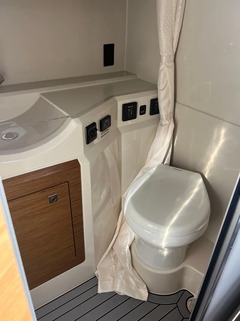 Slide: The Image of 2016 Cruisers Yachts 338 SOUTH BEACH bathroom with toilet and sink. - 16