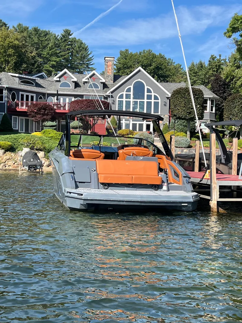 Slide: The Image of 2016 Cruisers Yachts 338 SOUTH BEACH docked by a luxurious lakeside home. - 2