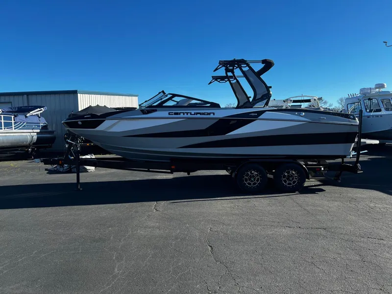 Slide: The Image of 2024 Centurion Fi23 boat on trailer, sleek design, parked outdoors. - 11