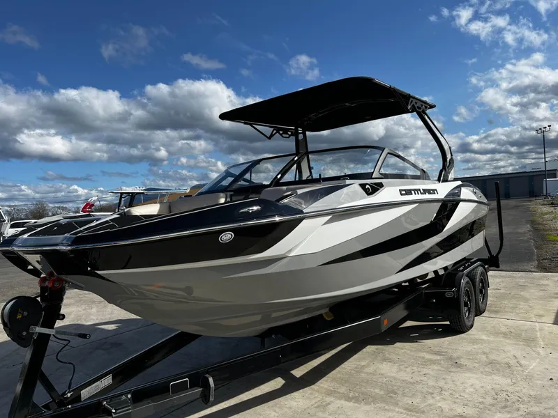 Slide: The Image of 2024 Centurion Fi23 boat on trailer under blue sky. - 3