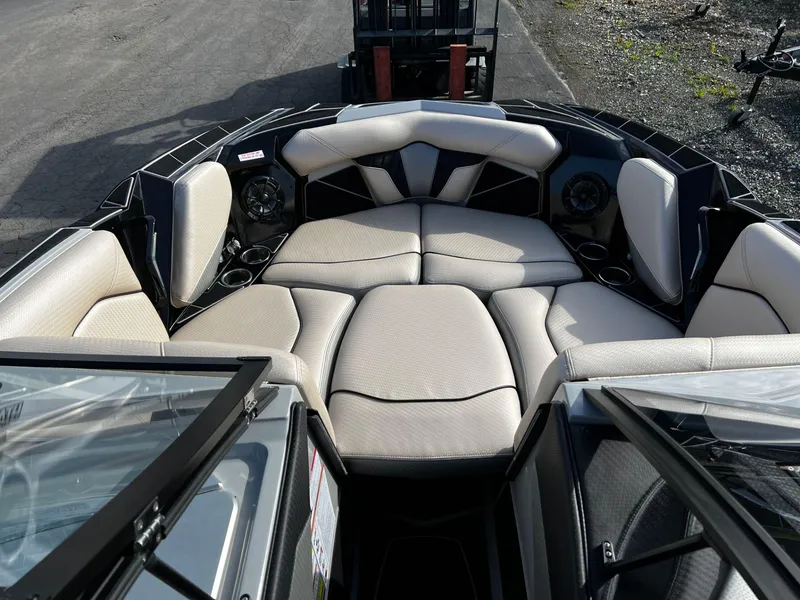 Slide: The Image of 2024 Centurion Fi23 boat interior with plush seating and cup holders. - 8