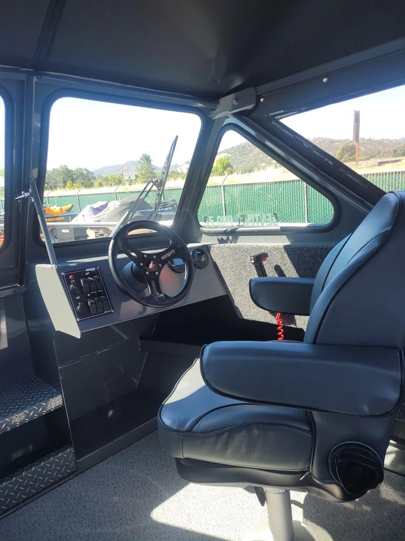Slide: The Image of Interior of 2024 BOULTON POWERBOATS SENTINEL PRO 22, featuring steering wheel and captain's chair. - 12
