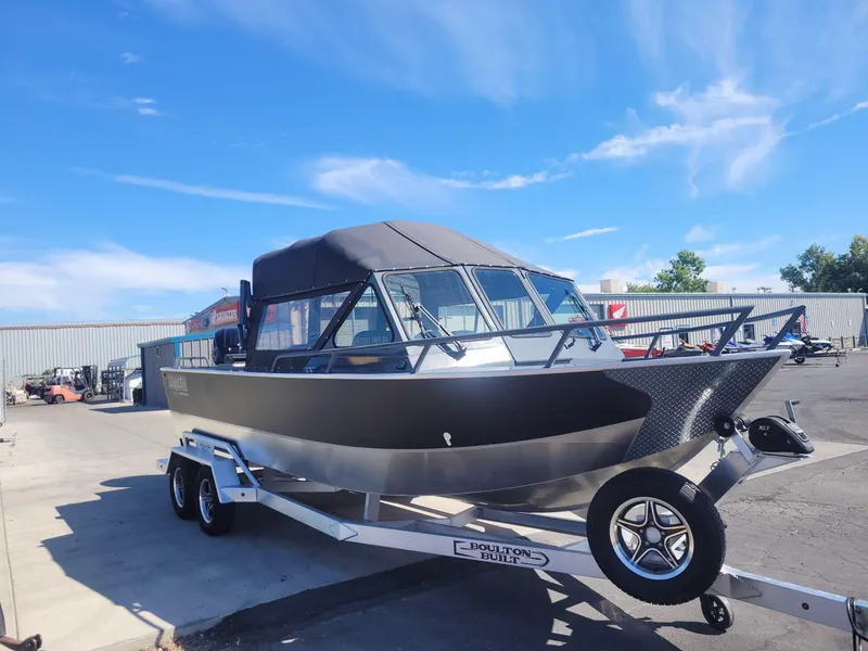 Slide: The Image of 2024 Boulton Powerboats Sentinel Pro 22 on trailer under clear blue sky. - 2