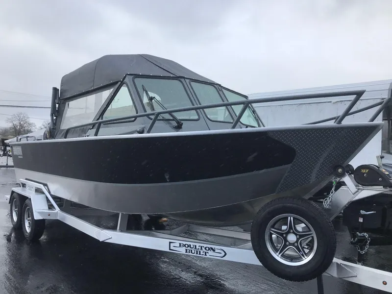 Slide: The Image of 2024 Boulton Powerboats Sentinel Pro 22 on trailer, sleek design, overcast day. - 3