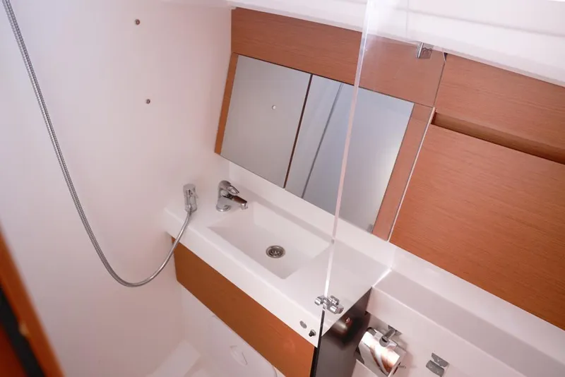 Slide: The Image of Modern bathroom in 2022 Jeanneau Sun Odyssey 410 yacht with sleek fixtures and mirror. - 10