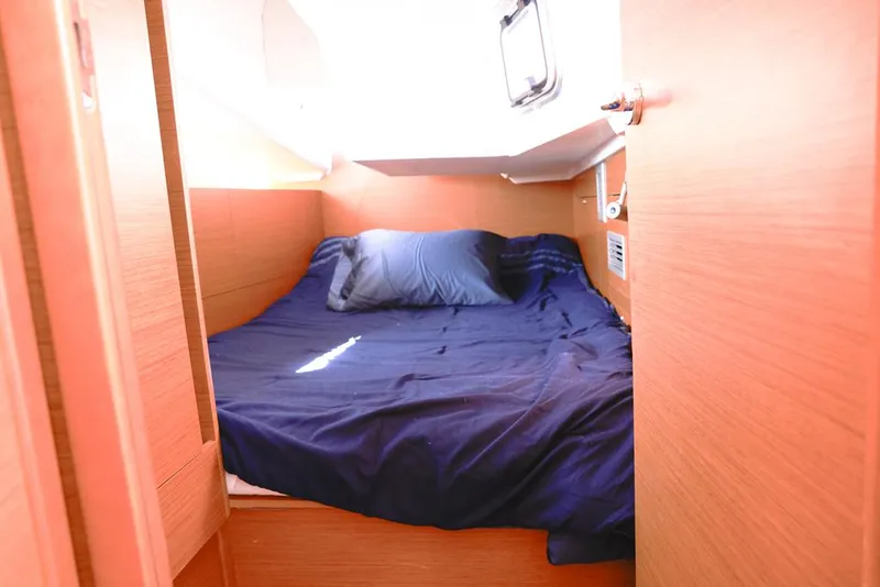 Slide: The Image of Cozy cabin interior of 2022 Jeanneau Sun Odyssey 410 with blue bedding. - 11
