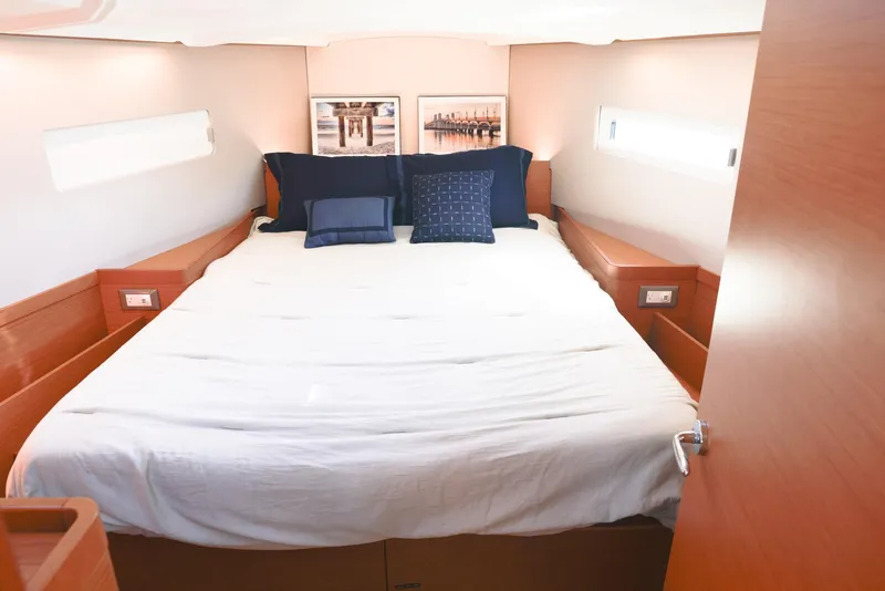 Slide: The Image of Luxurious cabin interior of 2022 Jeanneau Sun Odyssey 410 yacht with cozy bedding. - 12