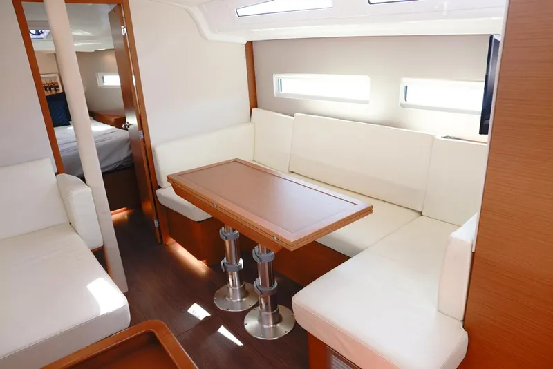 Slide: The Image of Interior of 2022 Jeanneau Sun Odyssey 410 yacht with modern seating and table. - 5