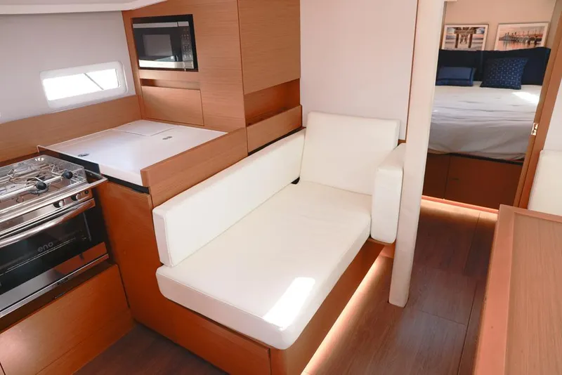 Slide: The Image of Interior of 2022 Jeanneau Sun Odyssey 410 yacht with modern kitchen and cozy seating. - 6