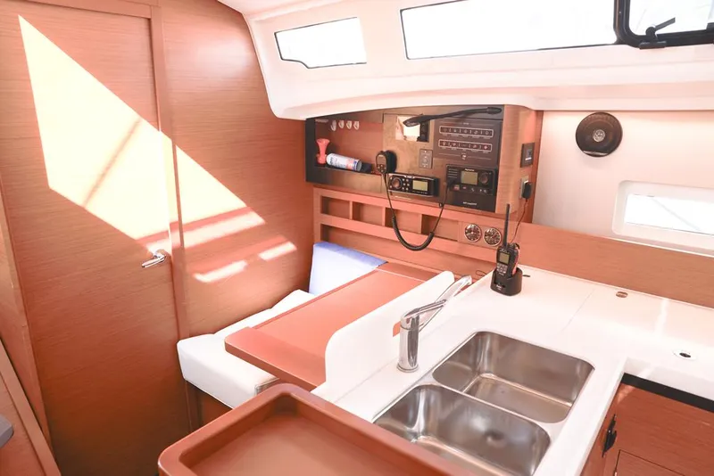 Slide: The Image of Interior of 2022 Jeanneau Sun Odyssey 410 yacht, featuring modern kitchen and navigation equipment. - 8