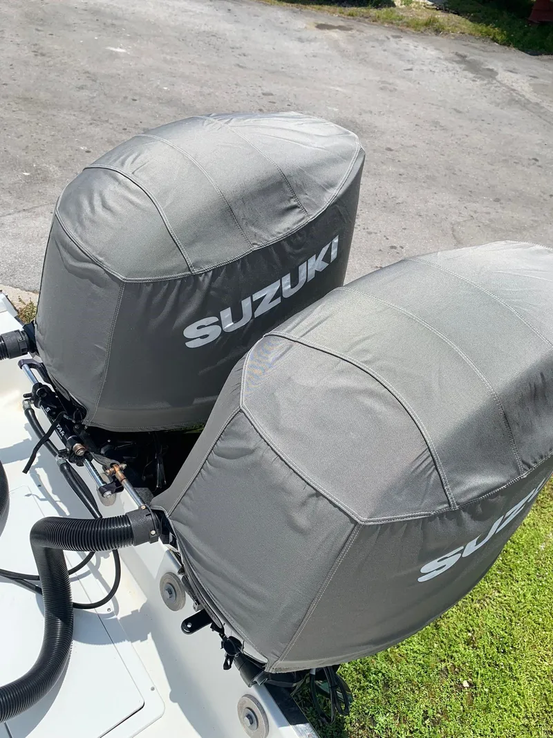 Slide: The Image of Twin Suzuki outboard motors on a 2000 Robalo 2640 Walkaround boat. - 11