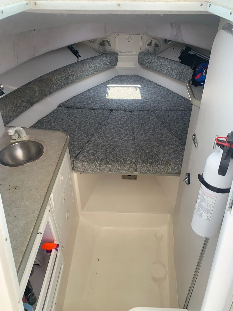 Slide: The Image of Interior of 2000 Robalo 2640 Walkaround boat with compact cabin and sink. - 15