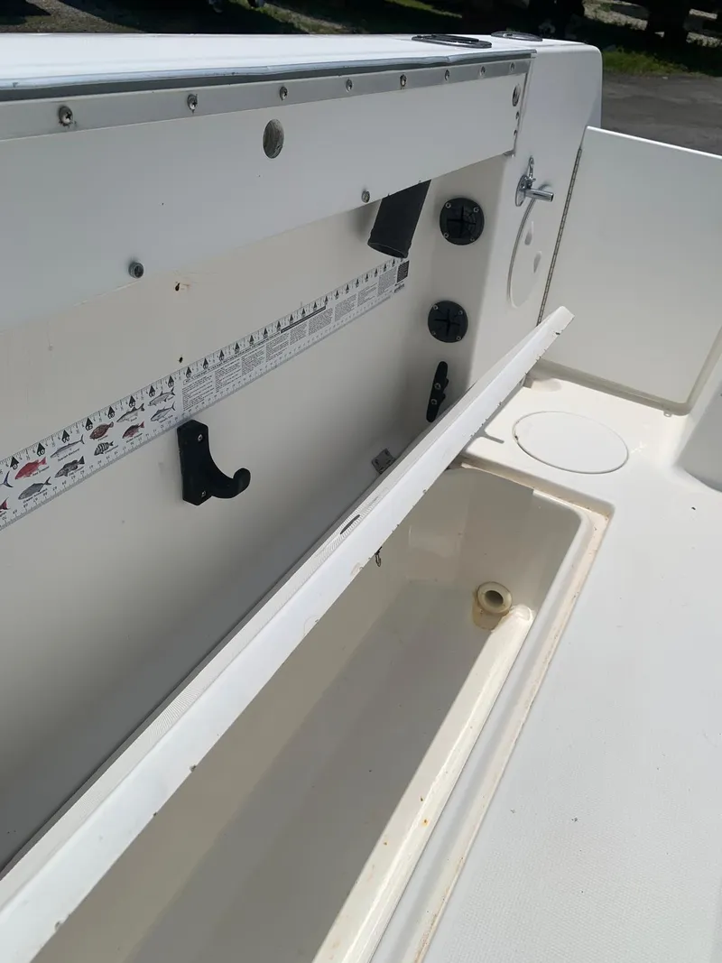 Slide: The Image of 2000 Robalo 2640 Walkaround boat interior with storage compartment open. - 17