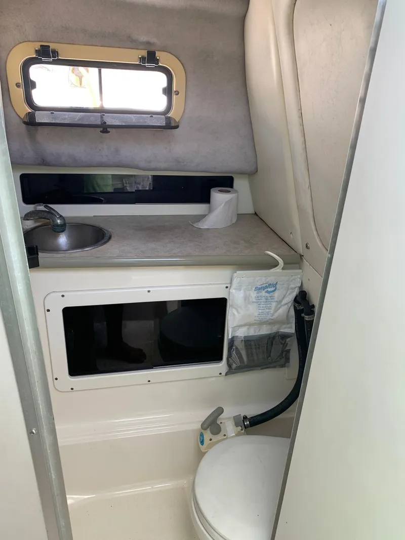 Slide: The Image of 2000 Robalo 2640 Walkaround boat cabin with sink and toilet. - 19