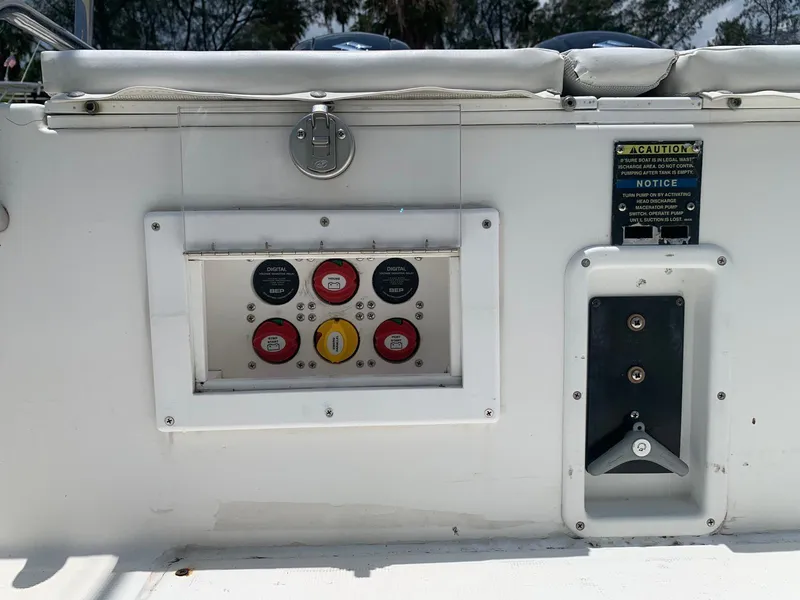 Slide: The Image of Control panel on 2000 Robalo 2640 Walkaround boat, featuring switches and caution labels. - 23
