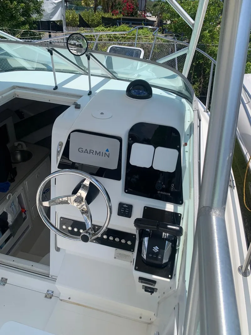 Slide: The Image of 2000 Robalo 2640 Walkaround boat helm with Garmin navigation system. - 26