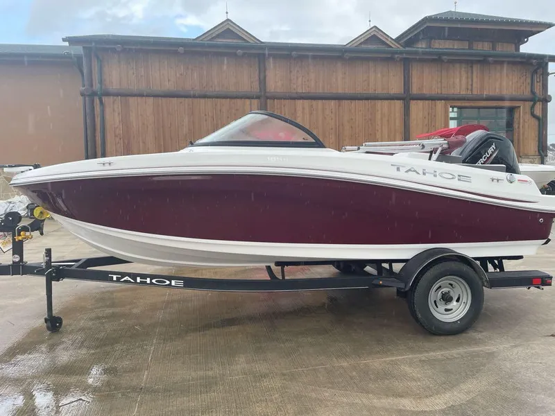 Slide: The Image of 2024 Tahoe 185 S boat on trailer, red and white design, parked outdoors. - 0