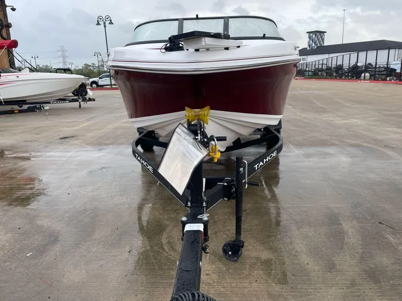 Slide: The Image of 2024 Tahoe 185 S boat on trailer, parked on wet concrete surface. - 2