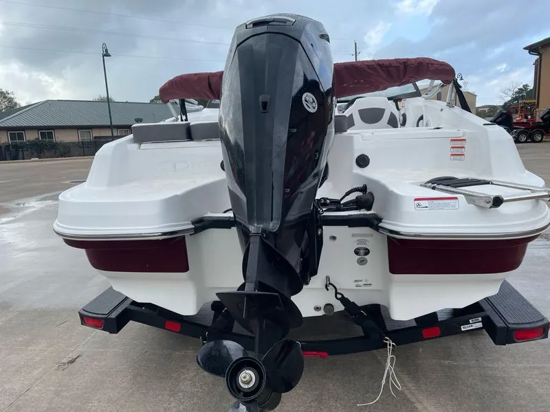 Slide: The Image of 2024 Tahoe 185 S boat with outboard motor on trailer, rear view. - 3