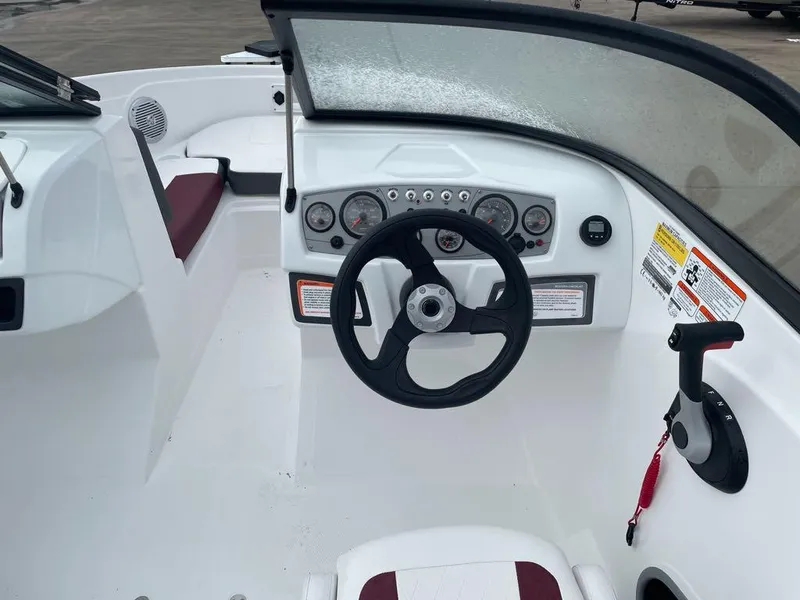Slide: The Image of 2024 Tahoe 185 S boat dashboard with steering wheel and control panel. - 4