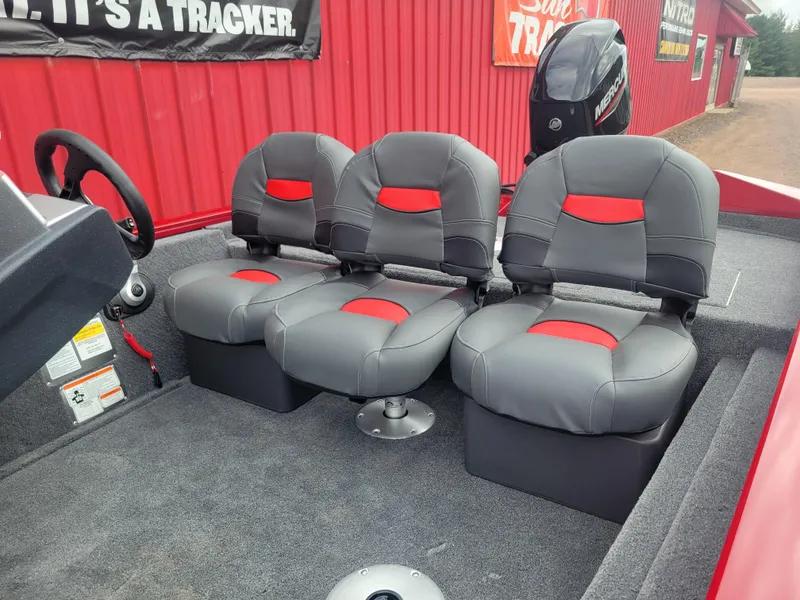 Slide: The Image of 2025 Tracker Pro Team 175 Crappie Edition boat interior with three gray and red seats. - 3