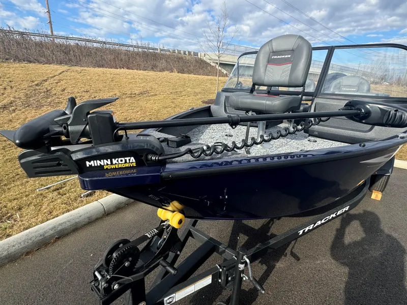 Slide: The Image of 2025 Tracker Pro Guide V-16 WT boat with Minn Kota PowerDrive motor on a trailer. - 2