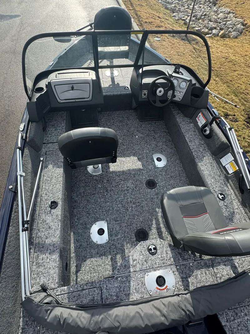 Slide: The Image of 2025 Tracker Pro Guide V-16 WT boat interior with seating and steering console. - 4