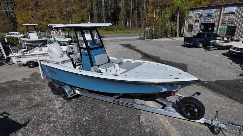 Slide: The Image of 2025 Blazer 2440 boat on trailer, parked outdoors, featuring sleek design and modern features. - 10