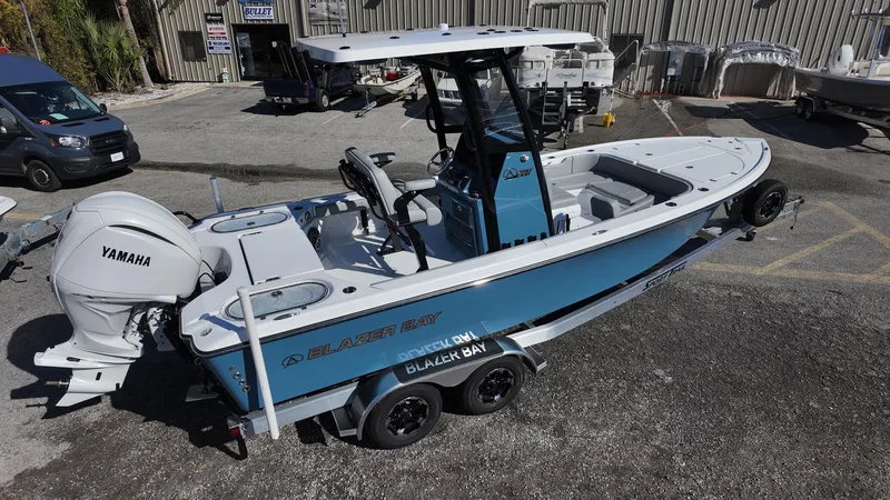 Slide: The Image of 2025 Blazer 2440 boat with Yamaha engine on trailer in outdoor setting. - 17