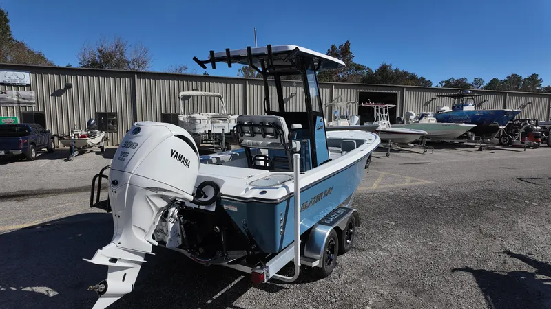 Slide: The Image of 2025 Blazer 2440 boat with Yamaha engine on trailer in marina. - 23