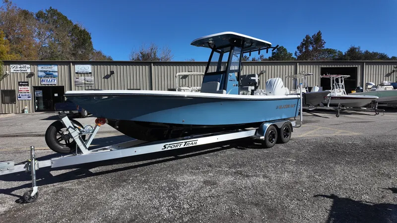 Slide: The Image of 2025 Blazer 2440 boat on trailer, parked outdoors near a warehouse. - 29