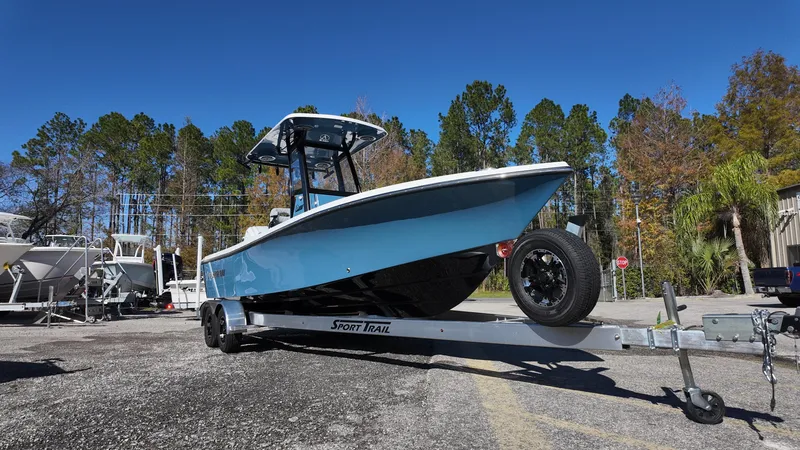 Slide: The Image of 2025 Blazer 2440 boat on trailer, parked outdoors under clear blue sky. - 3