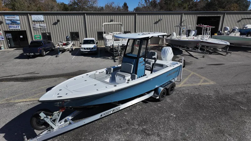 Slide: The Image of 2025 Blazer 2440 boat on trailer in marina parking lot. - 31