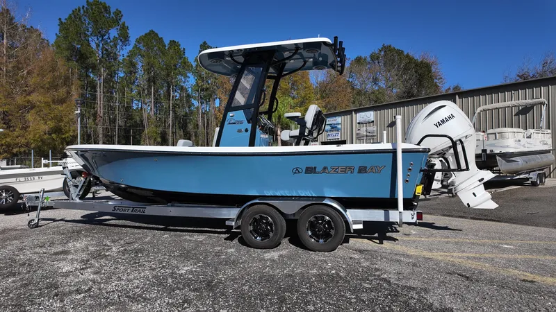 Slide: The Image of 2025 Blazer 2440 boat on trailer, blue hull, Yamaha engine, parked outdoors. - 35