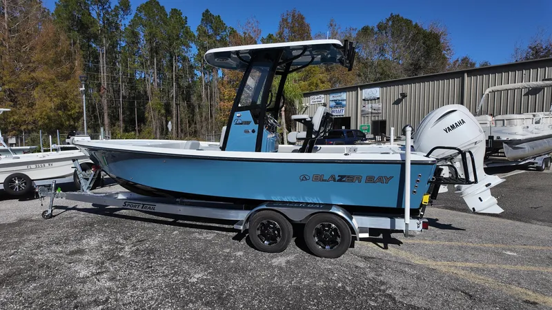 Slide: The Image of 2025 Blazer 2440 boat on trailer, blue hull, Yamaha engine, parked outdoors. - 36