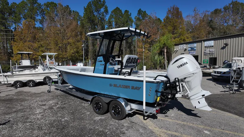 Slide: The Image of 2025 Blazer 2440 boat with Yamaha engine on trailer, parked outdoors. - 39