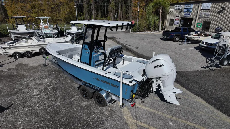 Slide: The Image of 2025 Blazer 2440 boat with Yamaha engine, parked outdoors on a trailer. - 40