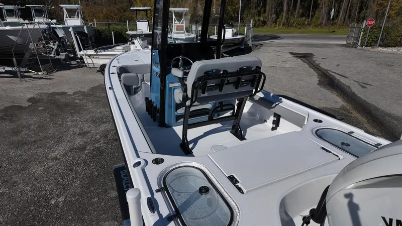 Slide: The Image of 2025 Blazer 2440 boat with spacious deck and seating, parked outdoors. - 42