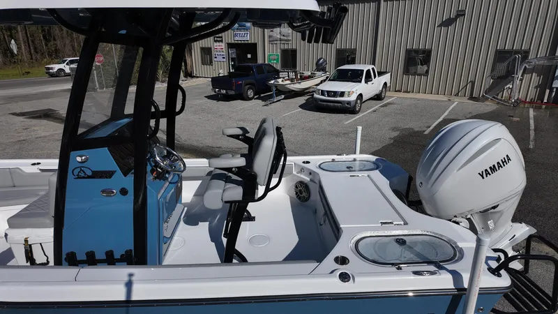 Slide: The Image of 2025 Blazer 2440 boat with Yamaha engine, parked outdoors near a building. - 46