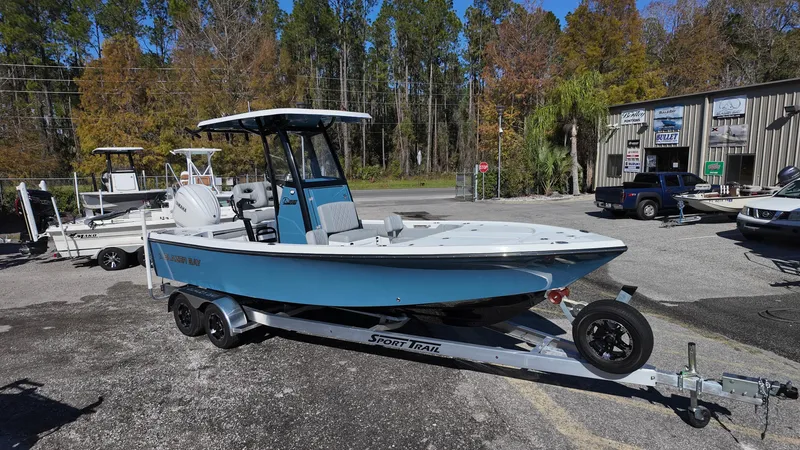 Slide: The Image of 2025 Blazer 2440 boat on trailer in outdoor dealership setting. - 9
