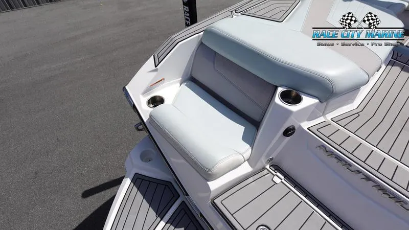 Slide: The Image of 2021 Nautique Super Air Nautique G23 boat with cushioned seating and cup holders. - 13