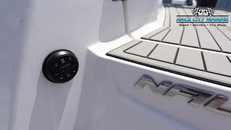 Slide: The Image of 2021 Nautique Super Air Nautique G23 boat deck with control panel, Race City Marine logo. - 14