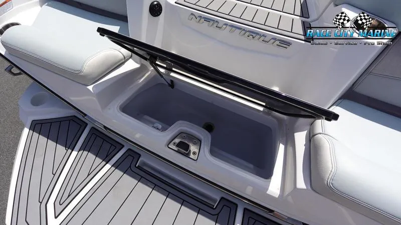 Slide: The Image of 2021 Nautique Super Air Nautique G23 boat storage compartment, open lid, Race City Marine logo. - 15