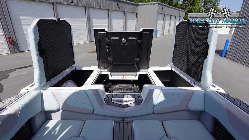 Slide: The Image of 2021 Nautique Super Air Nautique G23 boat interior with open storage compartments. - 17