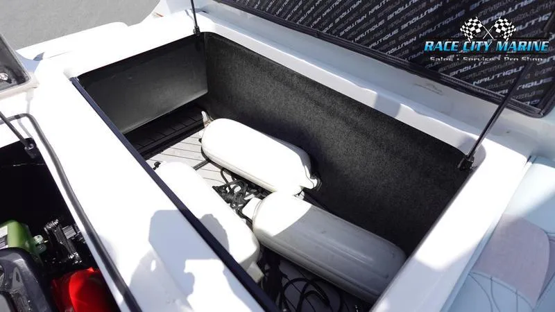 Slide: The Image of 2021 Nautique Super Air Nautique G23 storage compartment with white fenders. - 20